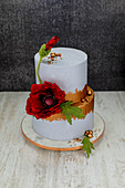 Festive double tier lavender cake decorated with poppy blossoms