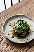 Zucchini and carrot pancakes with sour cream and pesto