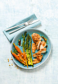 Chicken breast with green asparagus, carrots and peanut sauce