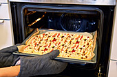 Put a baking tray into the oven