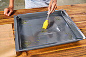 Baking paper on the tray slips away - fix with grease
