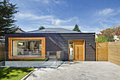 Renovated house with wooden elements and external staircase leading to the basement