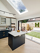 Center Kitchen island in a bright, open kitchen with terrace access