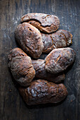 Several rustic breads on a wooden background