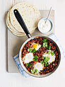 Chipotle bean chili with baked eggs