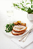 Rolled pork belly with herb-apricot-honey filling