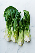 Asian cabbage bok choy on marble table close up