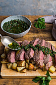 Steak and chimichurri on a bed of cubed potatoes