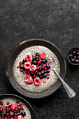 Chia seed pudding, topped with raspberries, blueberries and pomegrante seeds