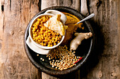 Dhal with roti bread, tTraditional indian yellow pea food dal with roti flatbread, served with lemon in ceramic bowl
