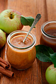 Apple Butter in a jar on a wooden surface