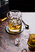 Old fashioned glass with whiskey and glass placer