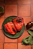 Appetizing roasted red pepper served on ceramic plate with oil