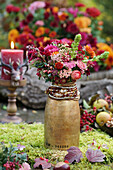 Autumn bouquet in a milk jug in the garden