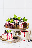 Blackcurrant and lemon poke cake with cream cheese frosting and blackcurrant sauce