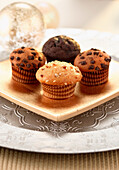 Assorted chocolate muffins on a golden serving platter