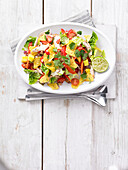 Salad with chicken, mango, jalapenos, and tortilla chips
