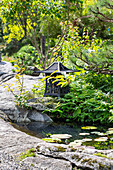Japanese metal lantern next to the pond