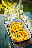 Grilled pumpkin wedges with fennel on a table in the garden