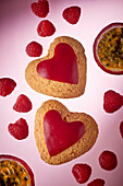 Heart-shaped biscuits with passion fruit and raspberries