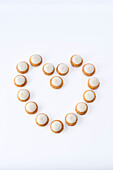Piped biscuits with white icing arranged in a heart shape