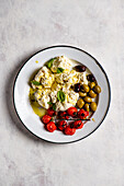 Home made ricotta with olives, olive oil, grilled tomatoes and basil