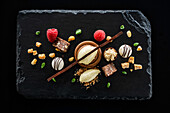 Dessert with chocolate, raspberries and ice cream on a black slate platter