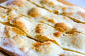 Freshly baked Italian focaccia cut into strips (close up)