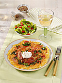 Hearty pancake with bacon, cabbage and sour cream