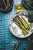 Green asparagus spears on porcelain plates