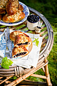 Pastry with blackcurrants on garden table