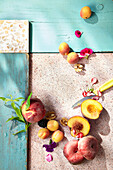 An arrangement of peaches, apricots, blackberries and walnuts