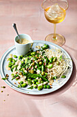 Pea and bean vegetables with ginger marinade and fried rice noodles