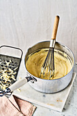 Cheese sauce with whisk in a saucepan