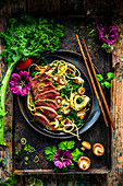 Beef teriyaki with noodles, shiitake mushrooms, and cabbage