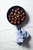 Top view of roasted chestnuts in a frying pan