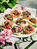 Spicy puff pastry with peppers, tomatoes, mozzarella, and anchovy fillets