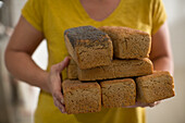 Woman holding various loaves
