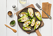 From above pear ricotta salad with lettuce on wooden cutting board on table