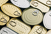 Top view row of different shapes of unopened cans