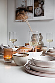 White kitchen table with dishes in beige tones