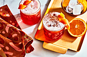 Campari with ice cubes and orange peel