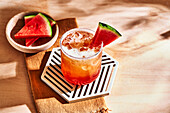 Tropical beer cocktail with ice cubes and watermelon