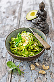 Vegan raw vegetable salad with pointed cabbage, cucumbe, r and spinach-lemon pesto (low carb)