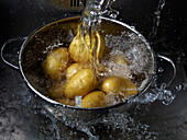 Rinsing potatoes with water