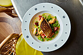 Roasted salmon with mussels, tomatoes, and broad beans
