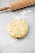 Sweet shortcrust pastry with rolling pin on work surface