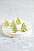 Baked Christmas trees with green icing and silver pearls