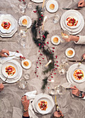 Paccheri mit Schweineragout in Tomatenrahmsauce und Erbsen auf weihnachtlich gedecktem Tisch