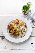 Yellow lentil patties with mashed potatoes, creamed kohlrabi and roasted onions (vegan)